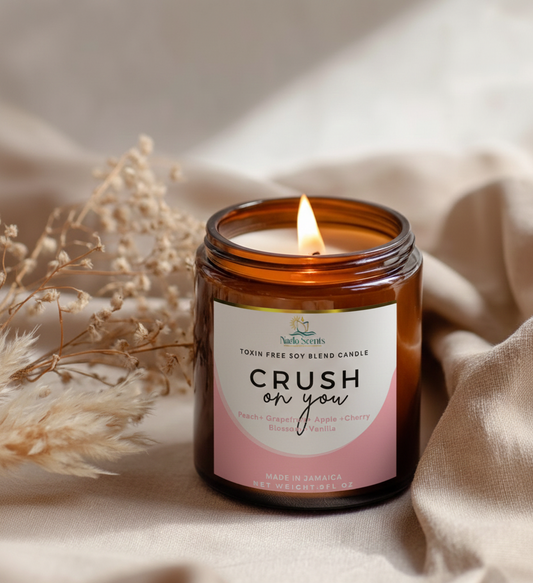 Candle in a glass jar labeled 'Crush on you' with a soft background